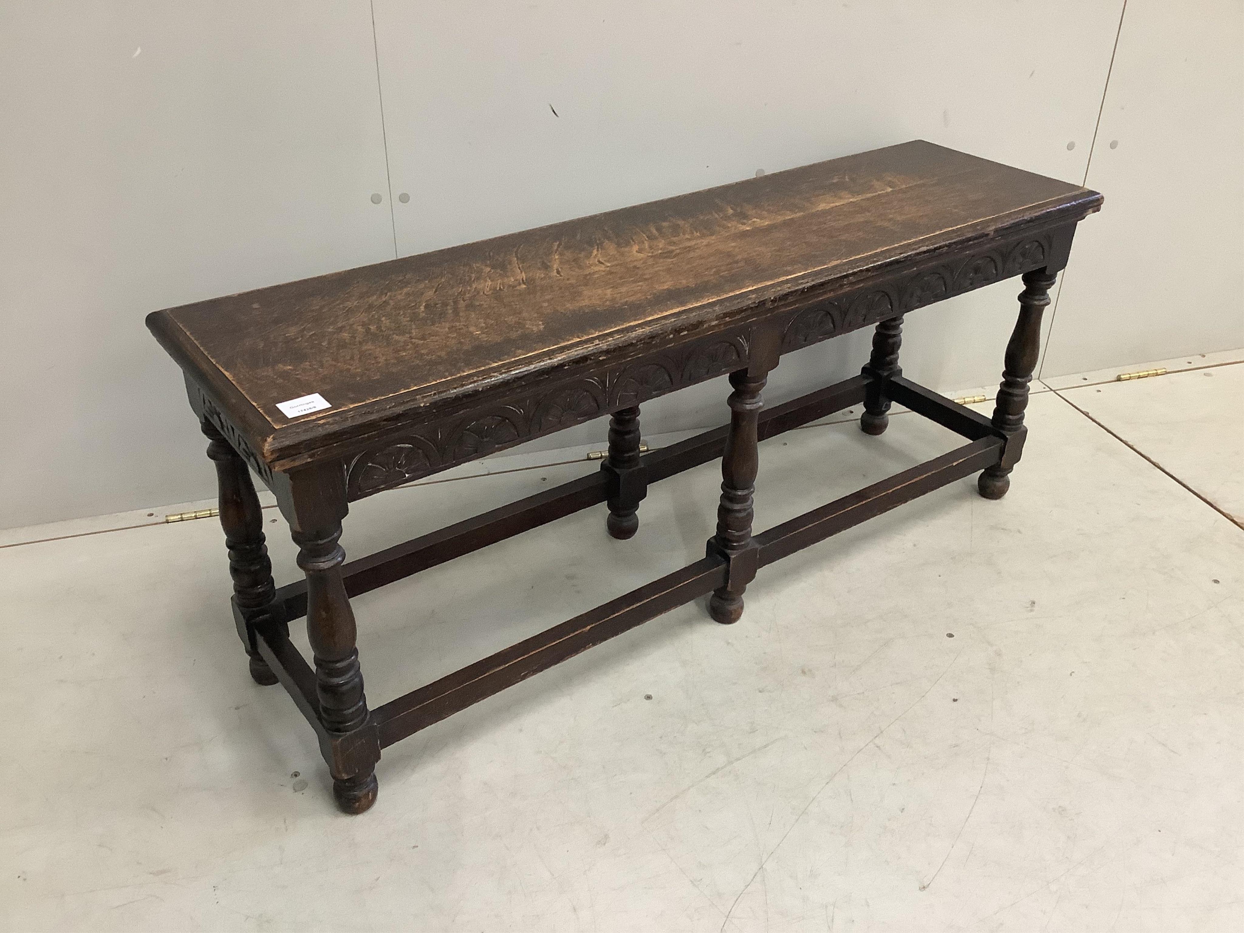 An early 20th century Jacobean Revival oak window seat, width 122cm, depth 34cm, height 51cm. Condition - fair